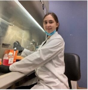 Alex Bidlack sitting at lab bench