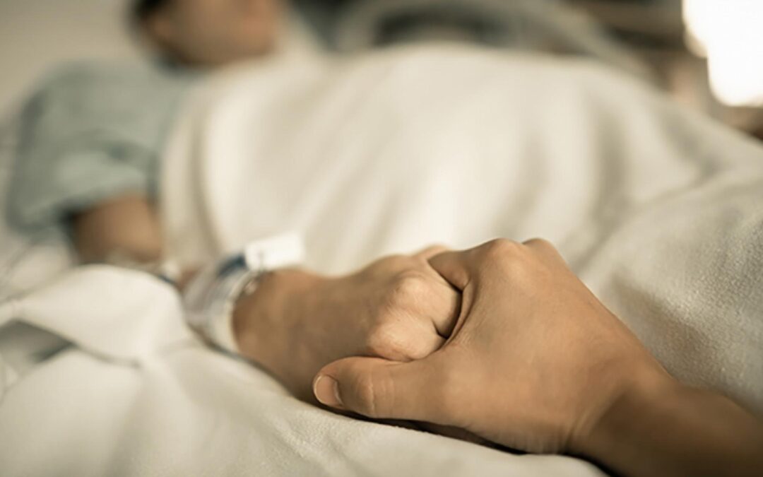Person-holding-hands-in-bed
