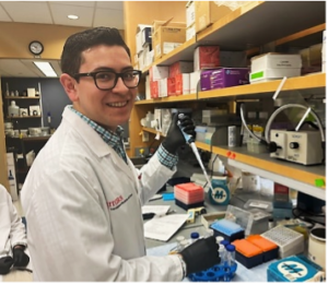 Santiago Castro Carillo at a lab bench wearing glasses and smiling