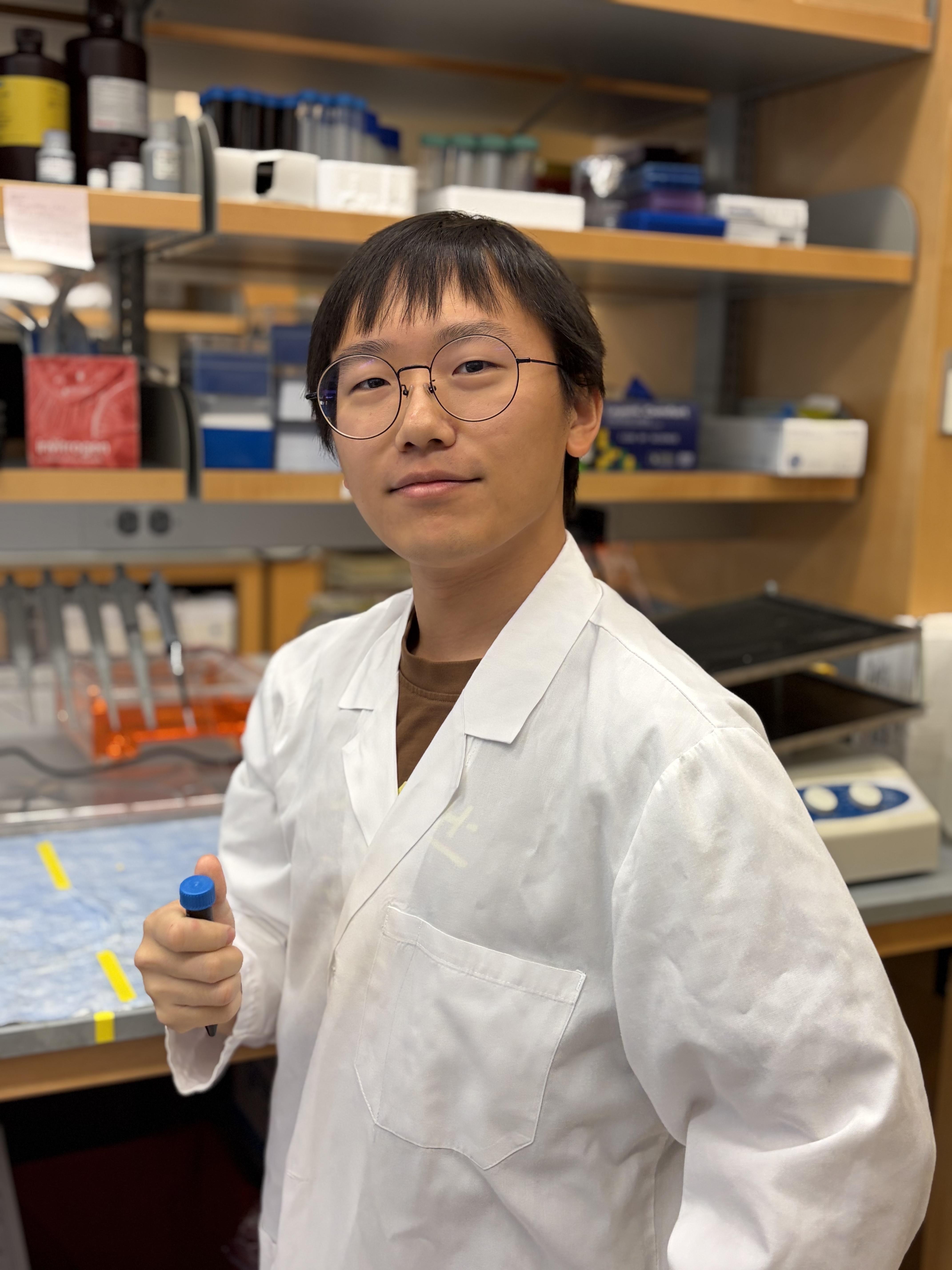 Youngwoo Lee in the lab holding a test tube