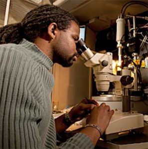 man using microscope photo