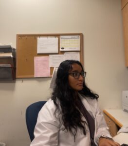  Sree Isukapalli sitting at desk in lab